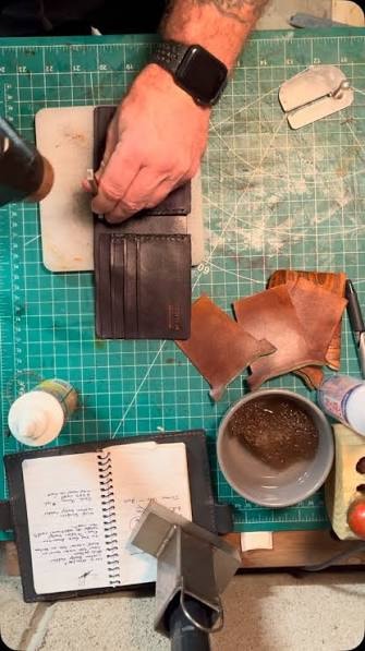 Artisan hands crafting leather