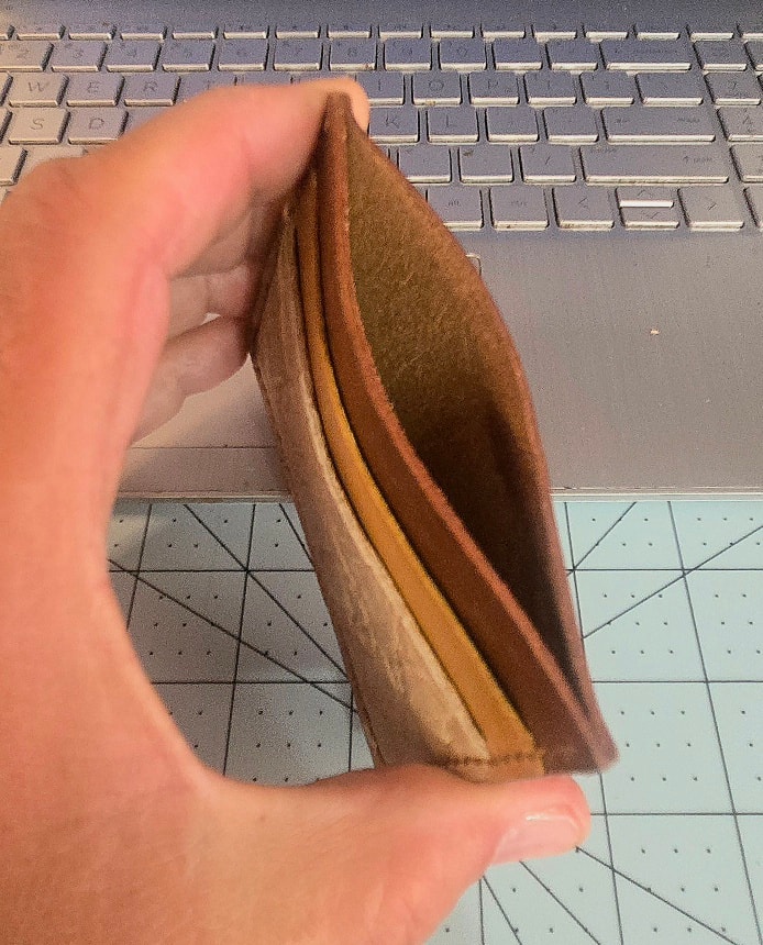 M1 African Elephant wallet — edge profile in hand showing slim build