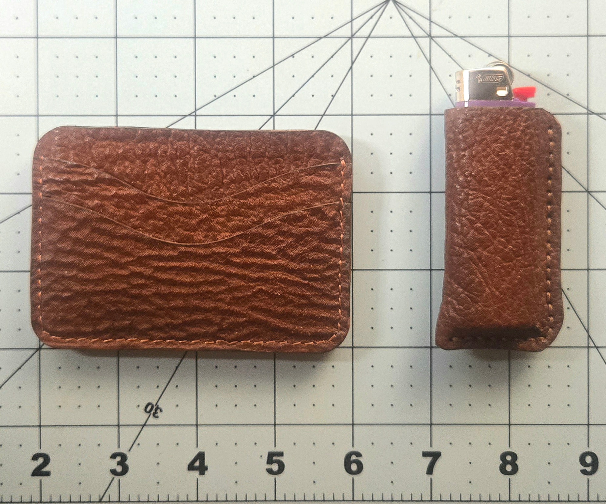 Wallet and lighter case together on cutting mat