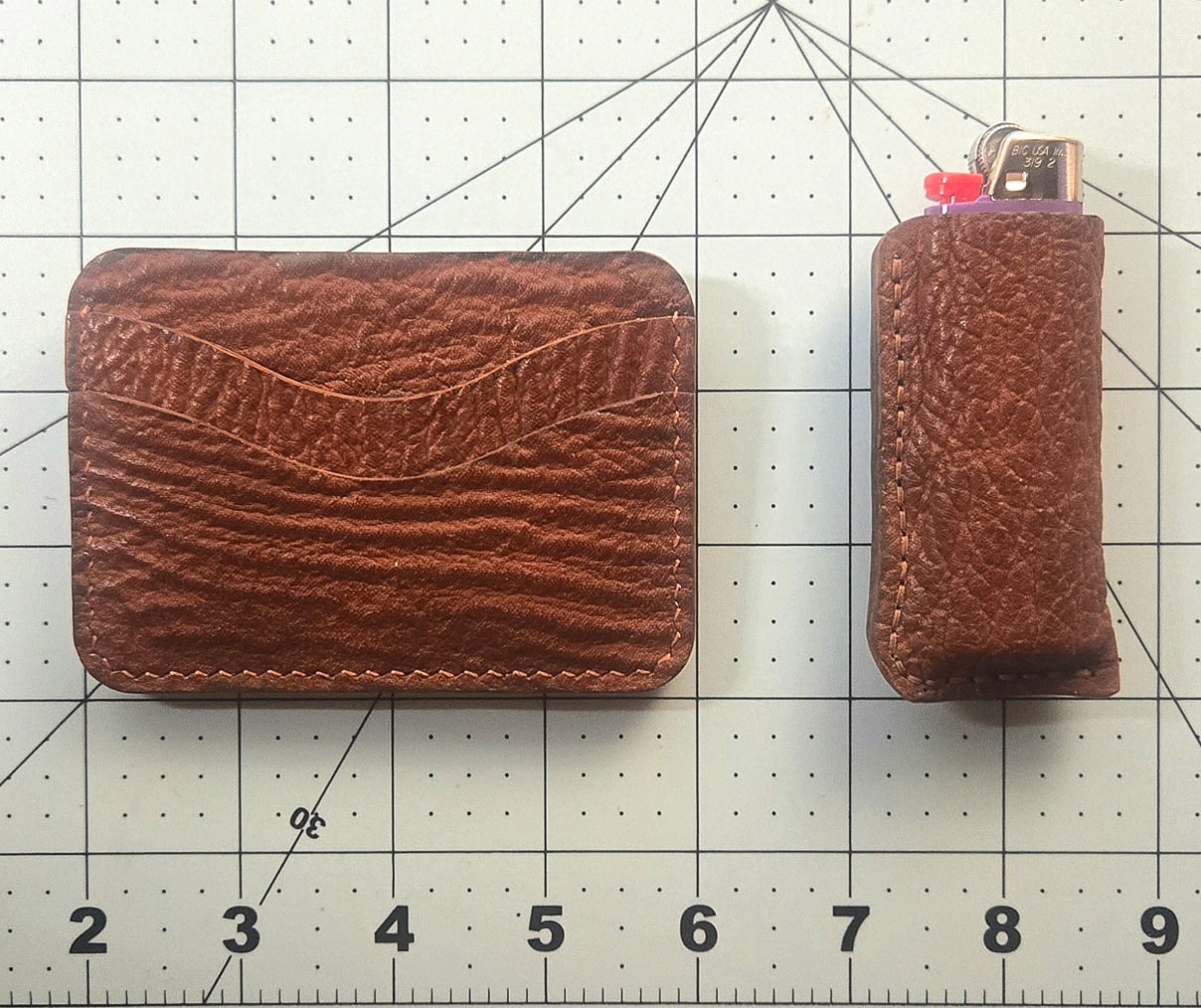 Wallet and lighter case — wider shot on cutting mat