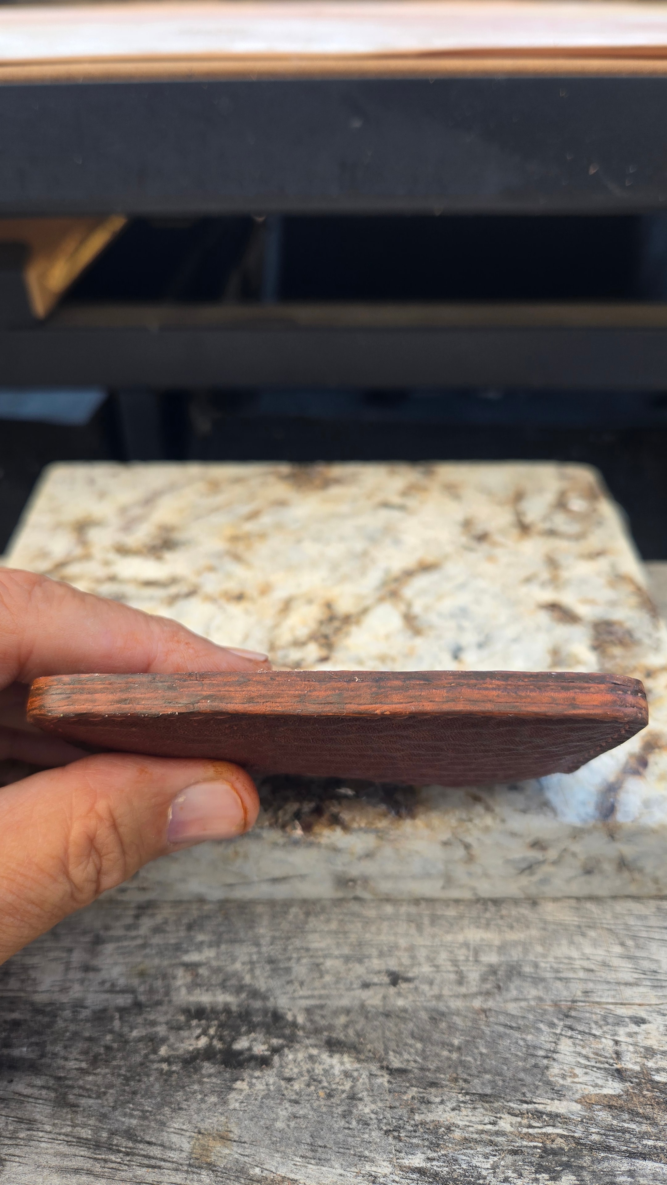 Wallet in hand — full side profile showing slim build